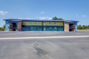 A two-story building with a flat roof, a parking lot in front, and a clear sky. - 15 Mi to Royal Gorge! Apartment in Cañon City (Canon City)
