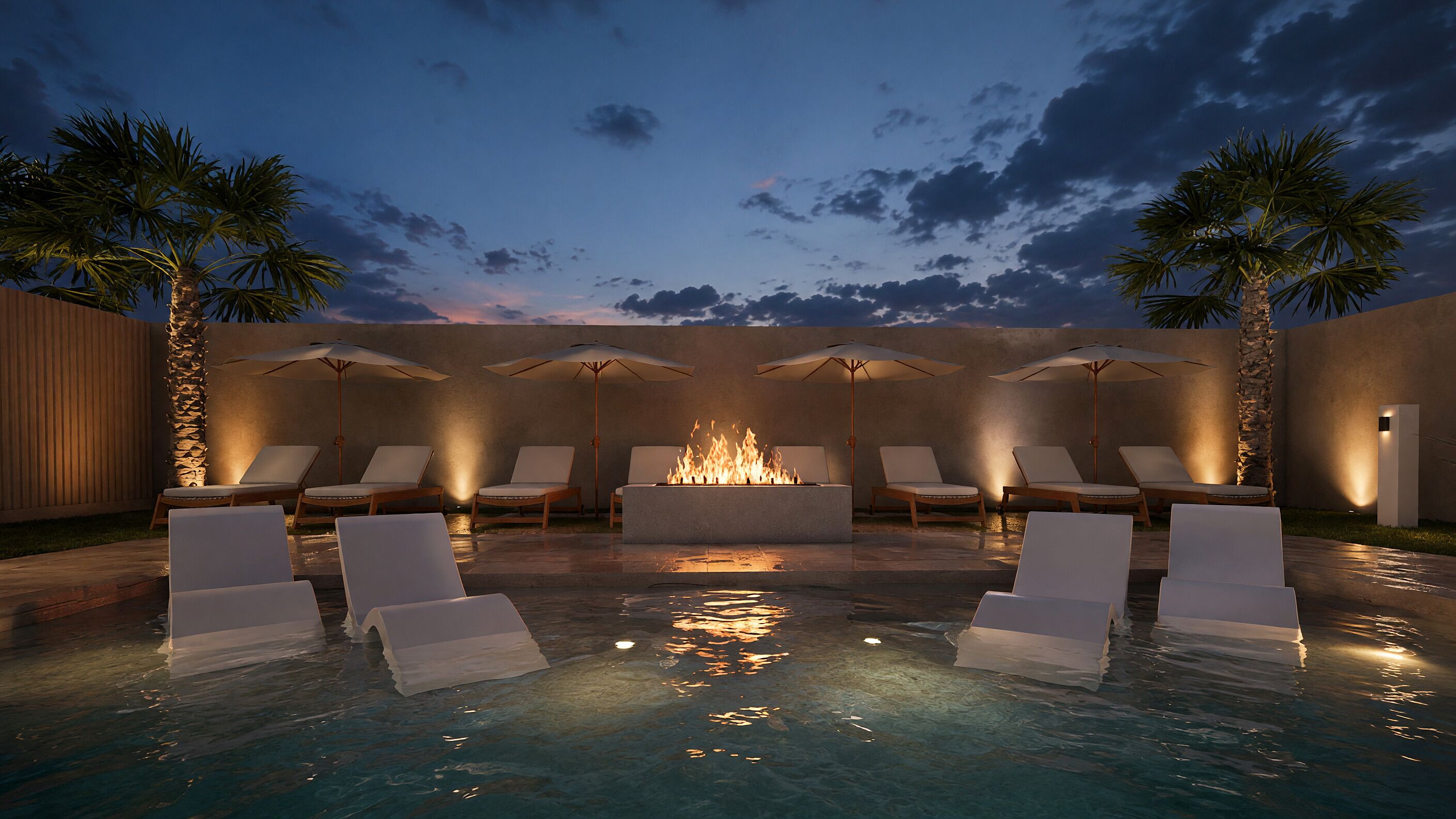 A pool area with lounge chairs and umbrellas, a fire feature, and palm trees.