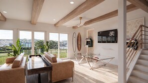 A spacious living area with a pool table, comfortable seating, a ceiling fan, and a view of the city. - The Estate | BRAND-NEW 2 Luxury Homes • Connected Backyards • Walk to Beach (Santa Rosa Beach)
