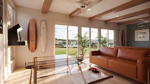 Un salon moderne avec une table basse en verre, un canapé en cuir et une vue sur un paysage verdoyant grâce à de grandes fenêtres.