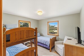 A bedroom with two bunk beds, a single bed, a desk with a computer, and a TV. - New Listing, Private Pool, Hot Tub, Walk to Beach, Dogs Welcome C0919 (Corolla)