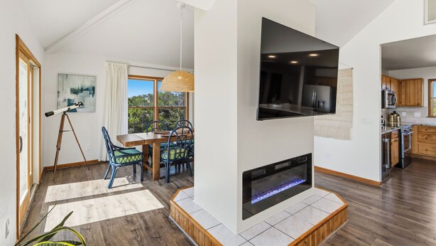 A modern living room with a fireplace, dining area, and kitchen. - New Listing, Private Pool, Hot Tub, Walk to Beach, Dogs Welcome C0919 (Corolla)