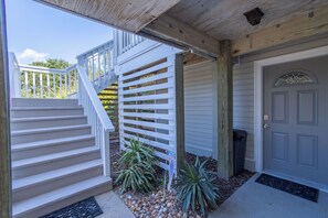 A residential property with a white staircase, a wooden deck, and a gray garage door. - New Listing, Private Pool, Hot Tub, Walk to Beach, Dogs Welcome C0919 (Corolla)