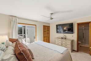 A bedroom with a bed, a dresser, a television, and a ceiling fan. - New Listing, Private Pool, Hot Tub, Walk to Beach, Dogs Welcome C0919 (Corolla)