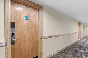 A hotel hallway with a wooden door marked '4312' and a 'NO SMOKING' sign. - Ski-Inspired Mountain Getaway Steps from Peak 9 and Main Street! (Breckenridge)