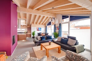 A modern living room with a high ceiling, wooden beams, a sofa set, a coffee table, and a view of the outside. - Powder Snow Loft - by Zermatt Apartment Rentals : Matterhorn Views, sleeps 6-7 (zermatt)