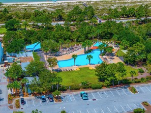 A resort with a swimming pool, lounge areas, and a parking lot. - 🌊Seaside Escape | Windmark Beach | Pool + Beach Access (WindMark Beach)