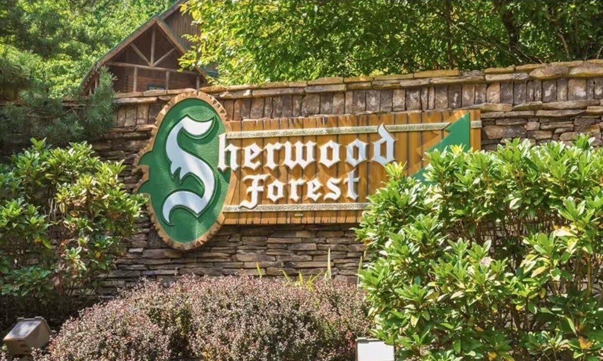 A sign for Sherwood Forest with a stylized 'S' logo and the name in white letters on a wooden background.