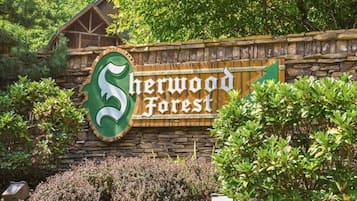 A sign for Sherwood Forest with a stylized 'S' logo and the name in white letters on a wooden background.