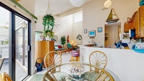 A modern interior with a dining area, kitchen, and living space. - East of the Sun 39866 E Sun Dr 327 (Fenwick Isle)