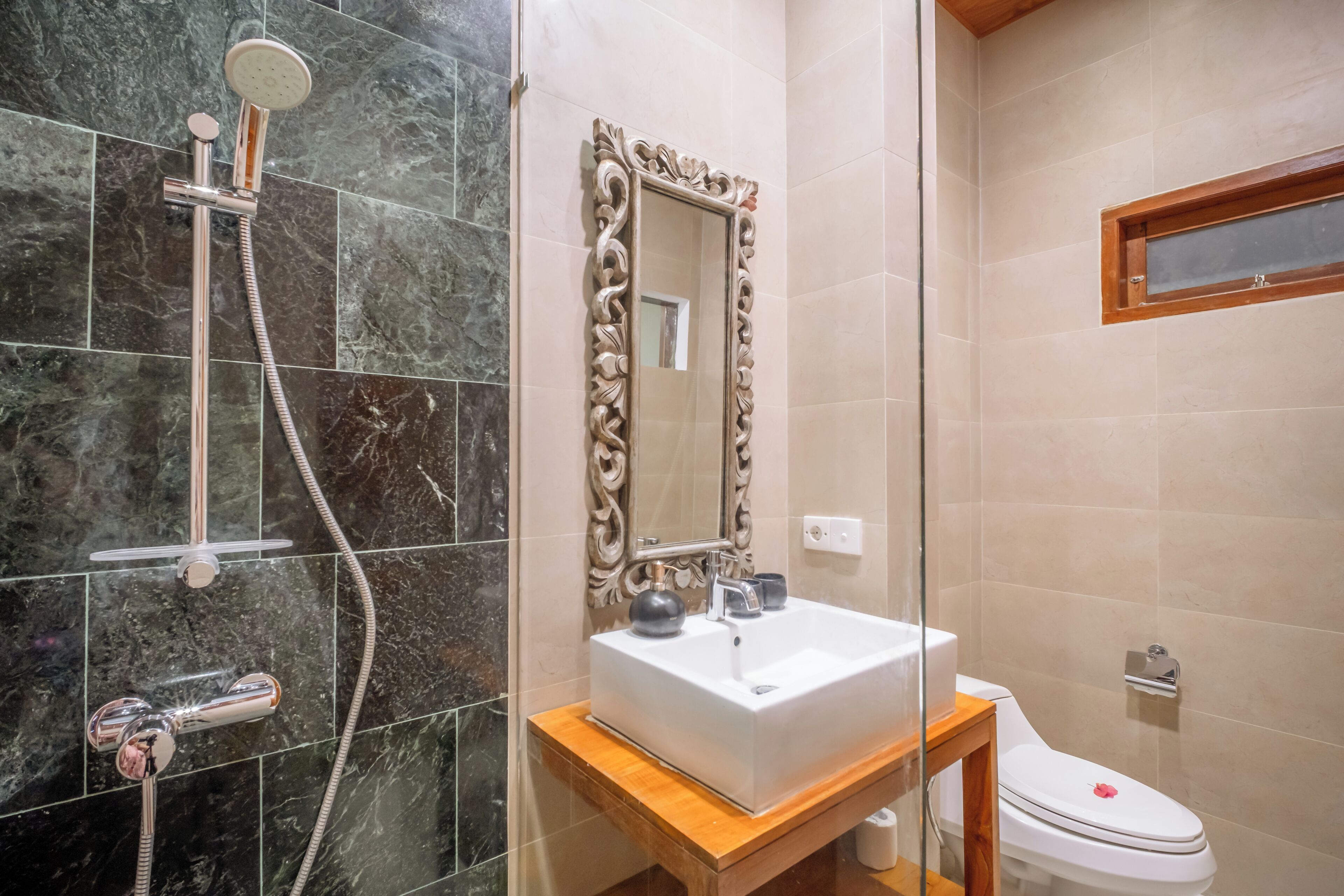 A bathroom with a shower, a sink, and a toilet.