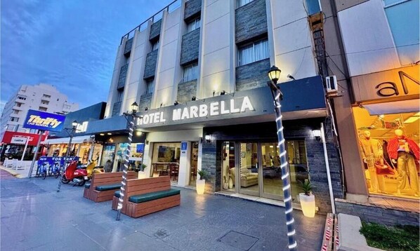 A hotel named 'HOTEL MARBELLA' with a modern facade, outdoor seating, and a visible entrance. - Hotel Marbella (Punta del Este)
