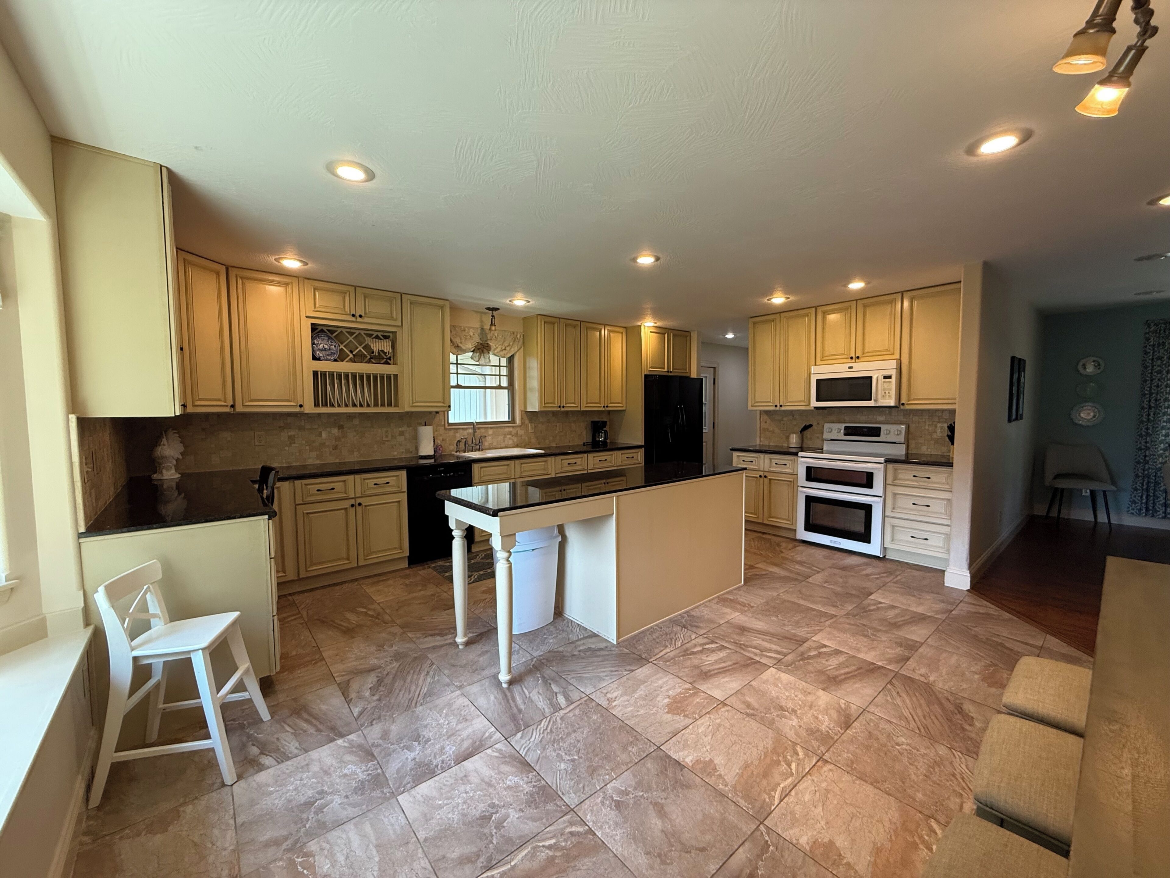 A spacious kitchen with a central island, built-in appliances, and ample counter space.