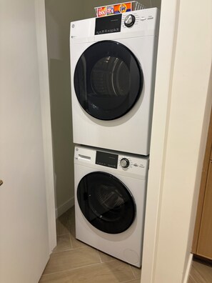 A stacked washer and dryer unit in a hallway. - Nomad Wynwood - Boutique luxury 1 bedroom+Den+2B (Miami)