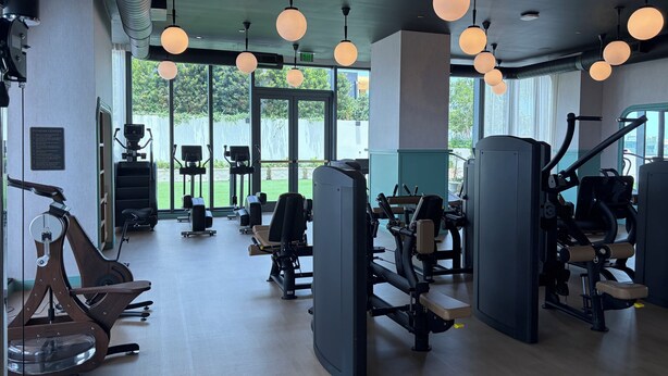 A fitness center with cardio machines, weight stations, and exercise equipment. - Nomad Wynwood - Boutique luxury 1 bedroom+Den+2B (Miami)