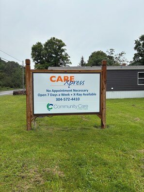 A sign for Community Care of West Virginia, indicating no appointment necessary, open 7 days a week, with a contact number. - Snowshoe Village Ski-in - Ski-out Condo w/ Hot Tub (1 Br / 1 Ba) (Snowshoe)