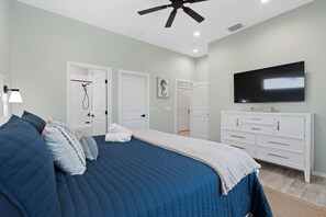 A bedroom with a bed, a television, a ceiling fan, and a dresser. - 🌴Seaside Cottage | Steps to the Beach 🏖️ Gulf Sunsets & Island Bliss 🌅 (Fort Myers Beach)