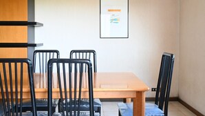 A room with a wooden table and four black chairs, a framed picture on the wall, and a light-colored floor. - A50 - Massignano, spacious four-room apartment (Massignano)