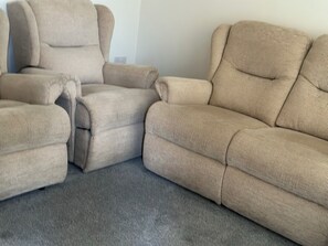 A sectional sofa with a ribbed texture, positioned on a grey carpet. - Sheffield Charm - Cozy 2 Bedroom House (Sheffield)