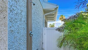 A gated area with a white door, a metal handle, and a small window. - Coastal Paradise- Brand new 4 bedroom with rooftop elevator (Holmes Beach)