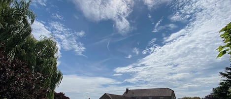 A grassy field with a house in the background.