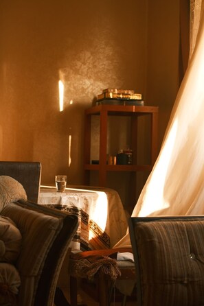 A room with a table, chairs, a cabinet, and a lamp. - Cozy 1-bedroom apartment in adorable Amman with AC (Amman)