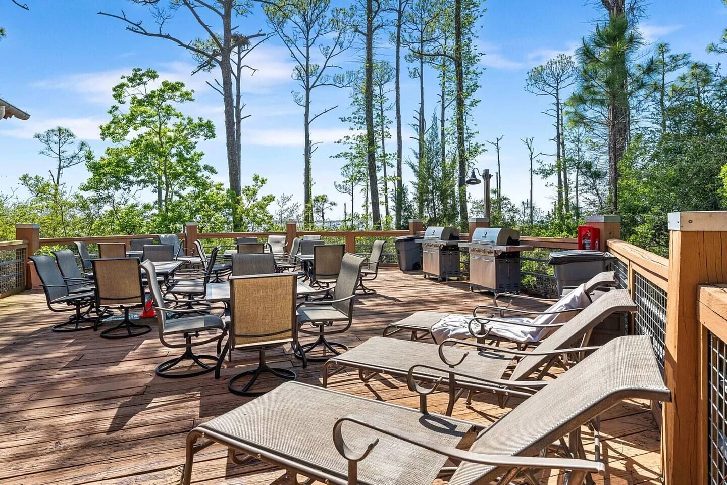 An outdoor deck with seating and barbecue grills.