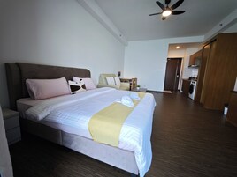 A hotel room with a bed, bedside table, and a ceiling fan.