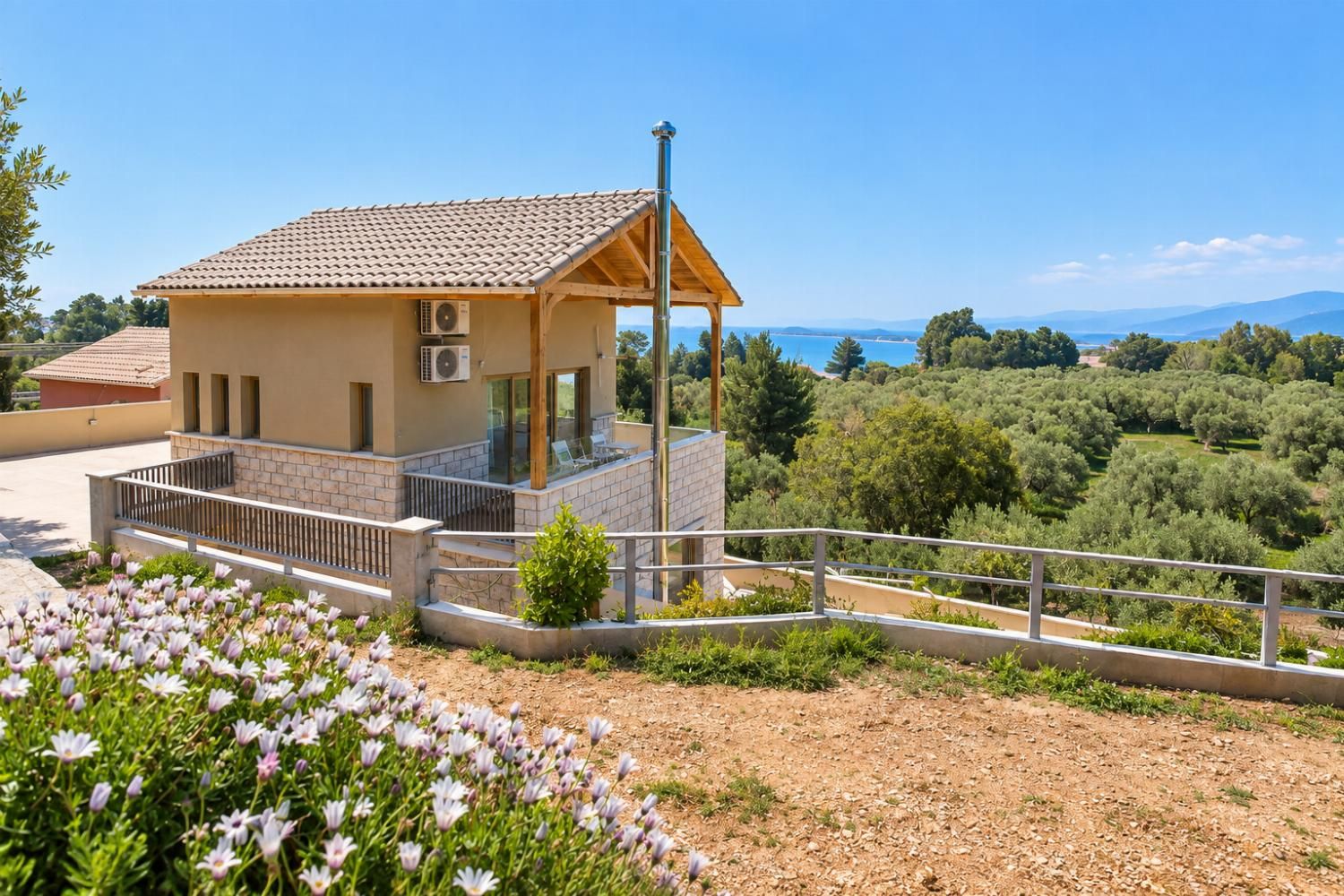 Un petit bâtiment doté d’un toit en tuiles, d’un balcon et offrant une vue sur la mer.