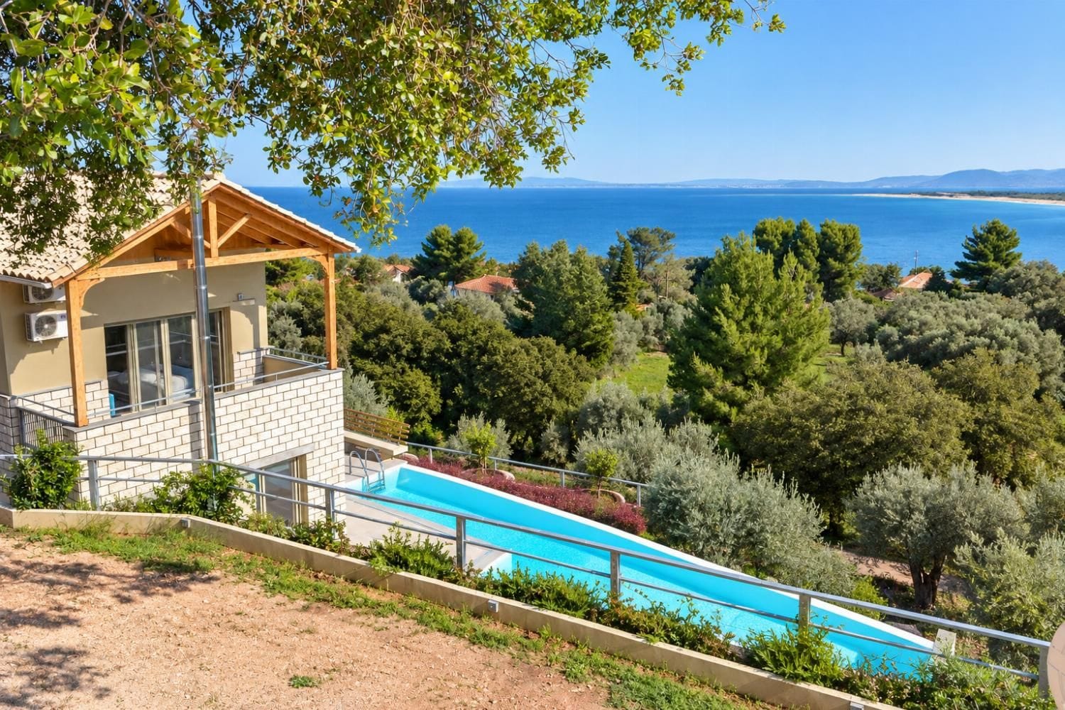Une villa moderne dotée d’une piscine, offrant une vue sur un paysage côtier.