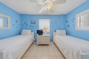 A room with two beds, a ceiling fan, a window with blinds, and wall decorations of marine life. - 🏖️ Seaside Beach + Racquet 3801 | Gulf Front Corner Condo + Wrap Balcony (Orange Beach)