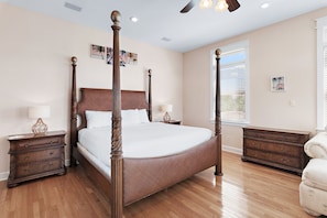 A four-poster bed with a wooden headboard, two bedside tables, and a window with blinds. - 🏖️ The Mermaid | Private Pool • 6 Bikes • Walk to Beach 🌊 (Inlet Beach)