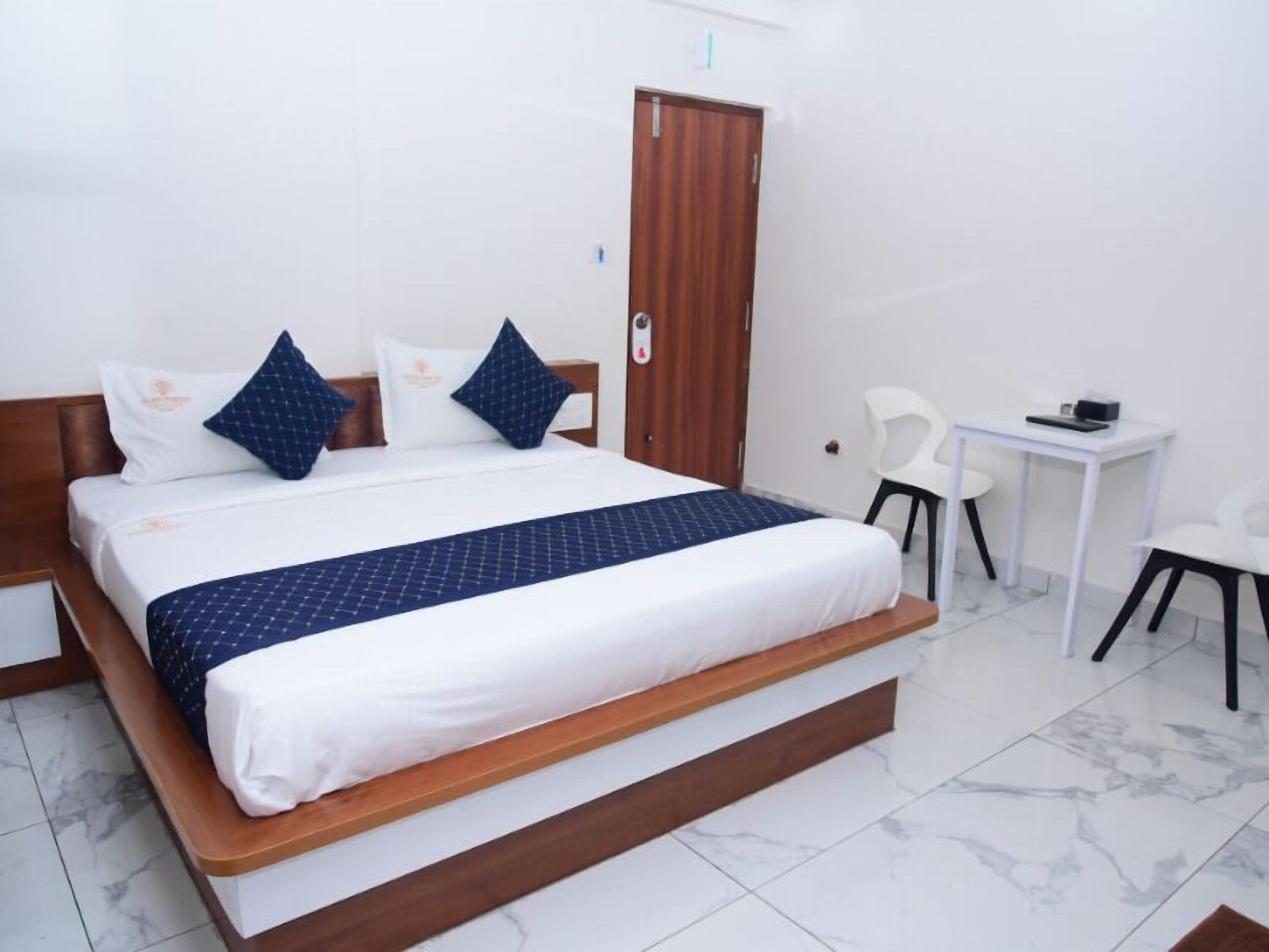 A room with a bed, a desk, and a chair.