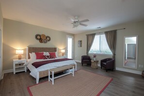 A bedroom with a bed, bedside tables, a ceiling fan, a window with curtains, and a view of the outside. - 360 degree vineyard views on 2 acres, patio, outdoor kitchen, game-room, dogs ok (Paso Robles)