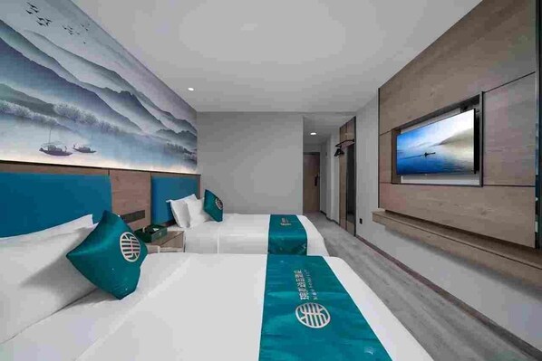 A hotel room with two beds, a large wall mural, a television, and a view of the sea.