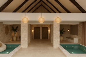 Ein Wellnessbereich mit zwei Pools, steinernen Säulen und Pendelleuchten.