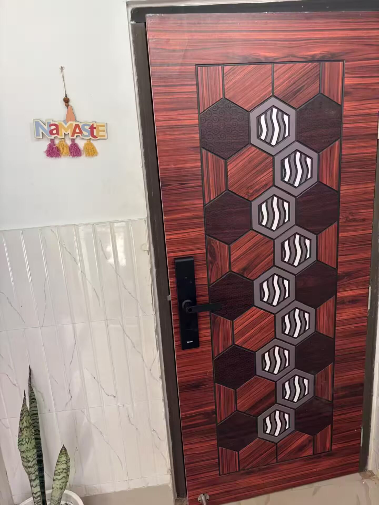 A wooden door with a geometric pattern and a keyhole.