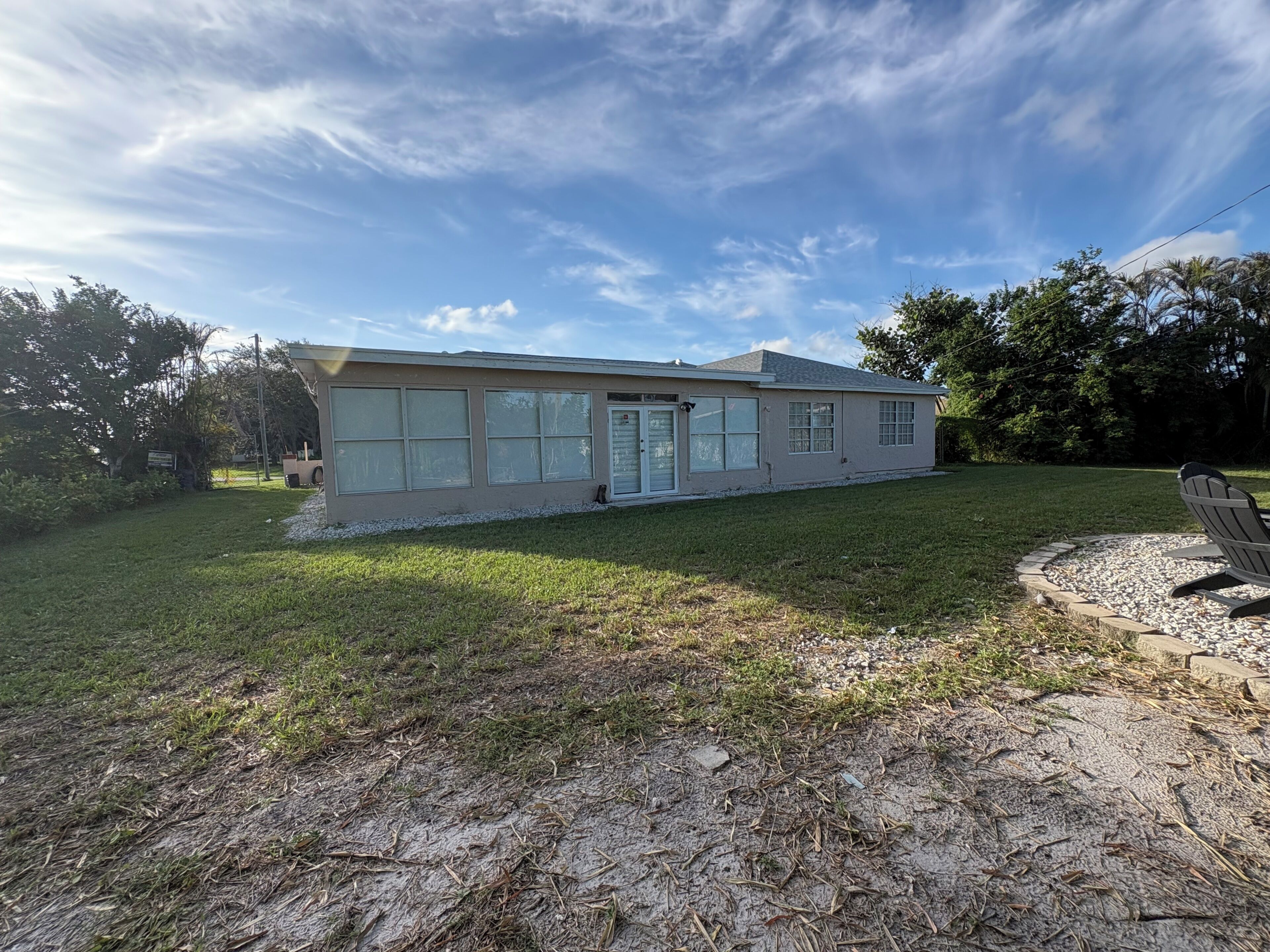 A single-story house with a front porch, a garage, and a well-maintained lawn.