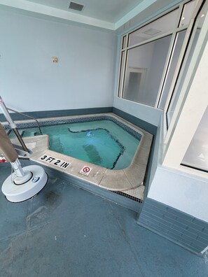 A small indoor swimming pool with a '3 FT 2 IN' depth marking and a 'NO SWIMMING' sign.