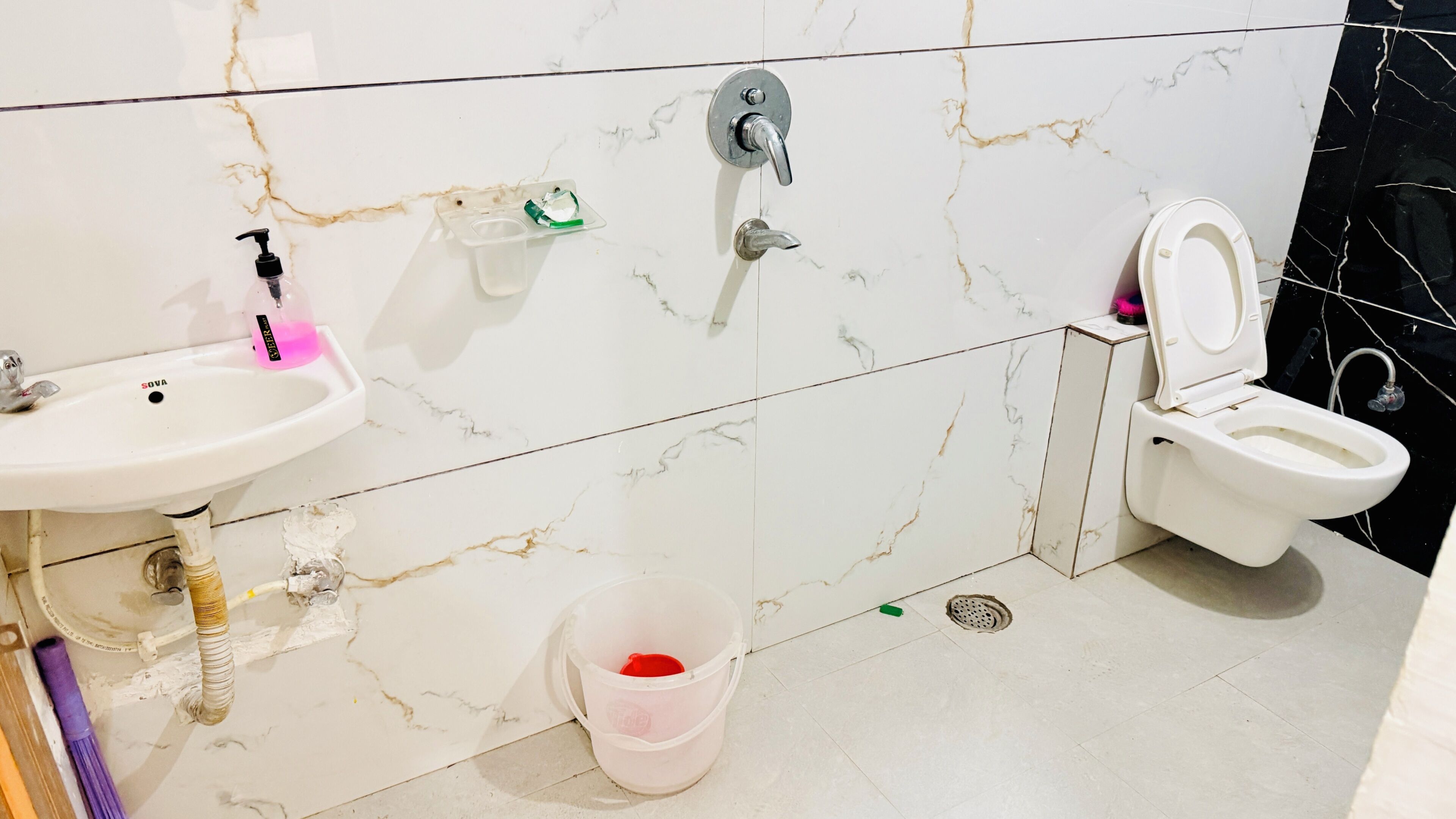 A bathroom with a sink, toilet, and bidet.