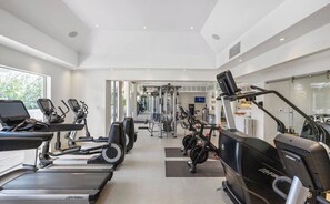A modern gym with treadmills, stationary bikes, and weight machines. - Luxury Villa | Casa WED | Bahia Beach PR (Rio Grande)