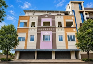 A multi-story building with a central entrance, multiple windows, and a flat roof. - Classic Gajuwaka (Visakhapatnam)