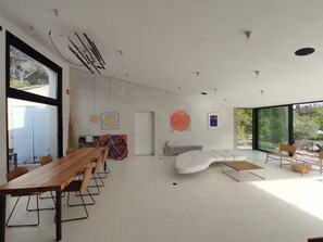 A modern interior with a dining area, seating, and artwork. - Villa Cézanne Panorama, Downtown Within Walking Distance (Aix-en-Provence)