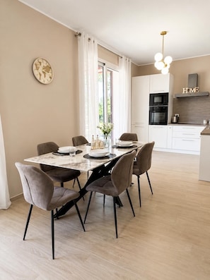A modern kitchen with white cabinets, a built-in oven, and a microwave. - Relaxation, comfort, and nature, with on-site parking and a terrace, just 5 minutes from the beach. (Trappitello)
