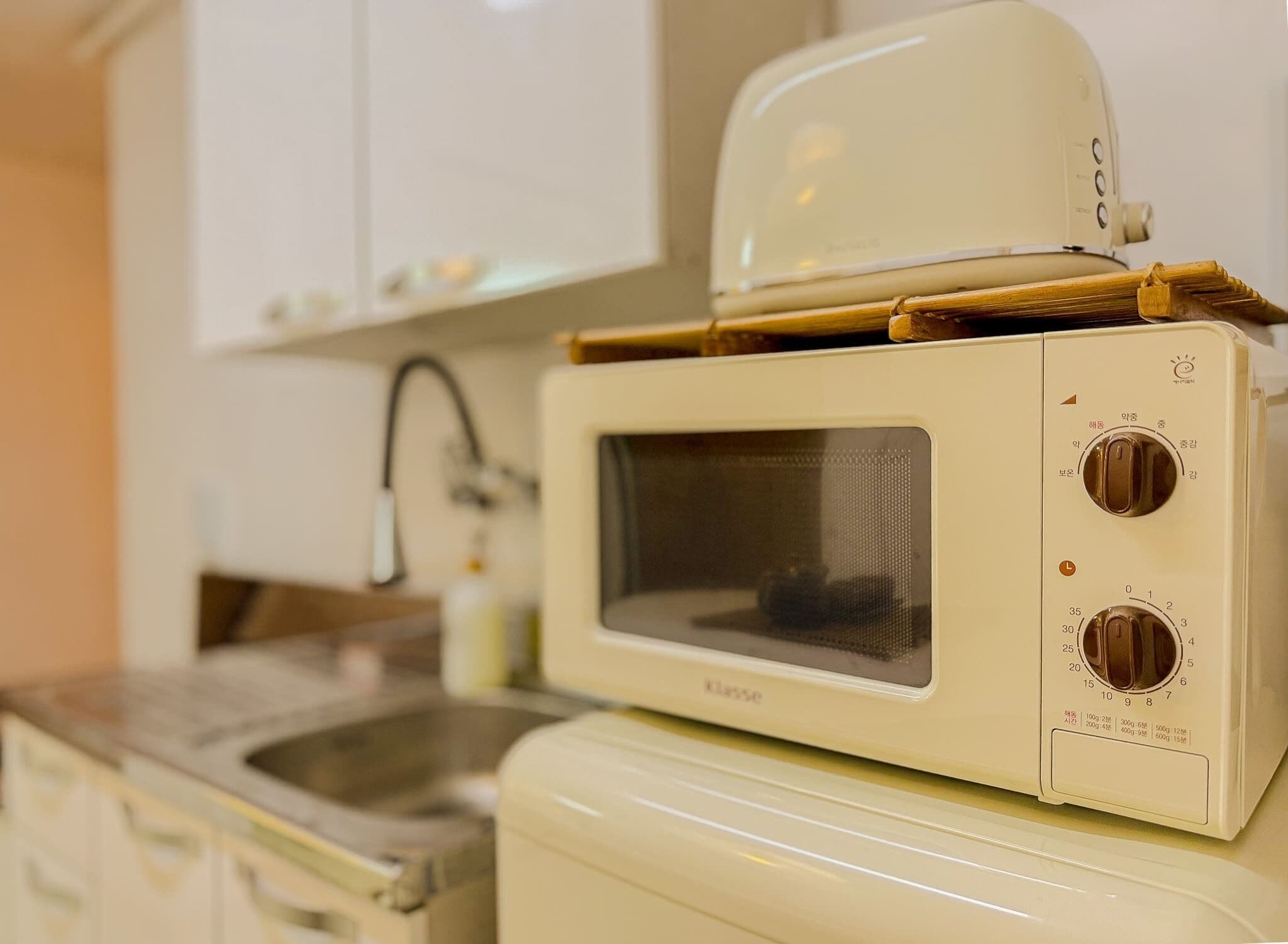 A compact kitchen with a microwave oven and a small sink.