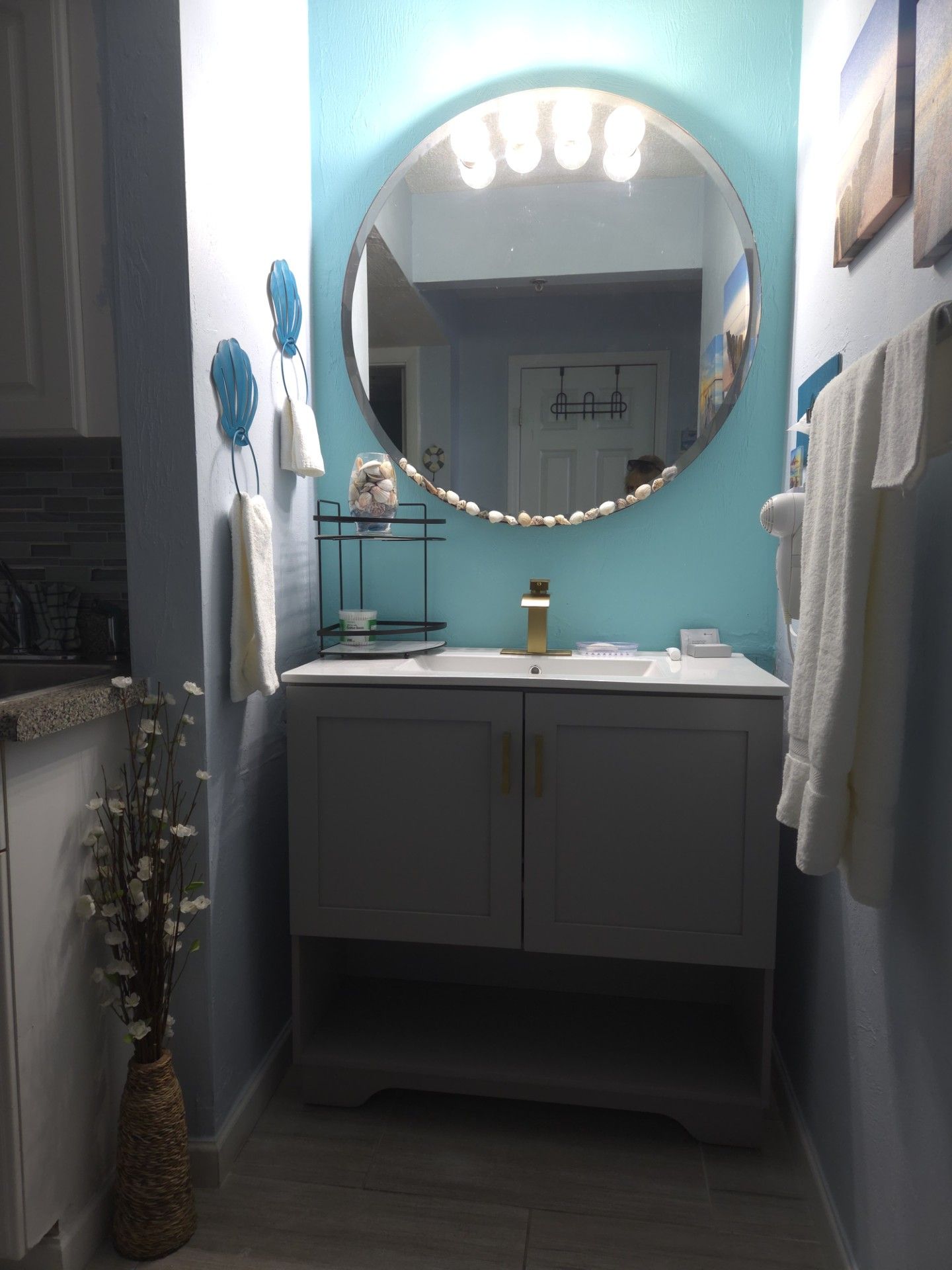 A bathroom with a vanity, a mirror, and a sink.