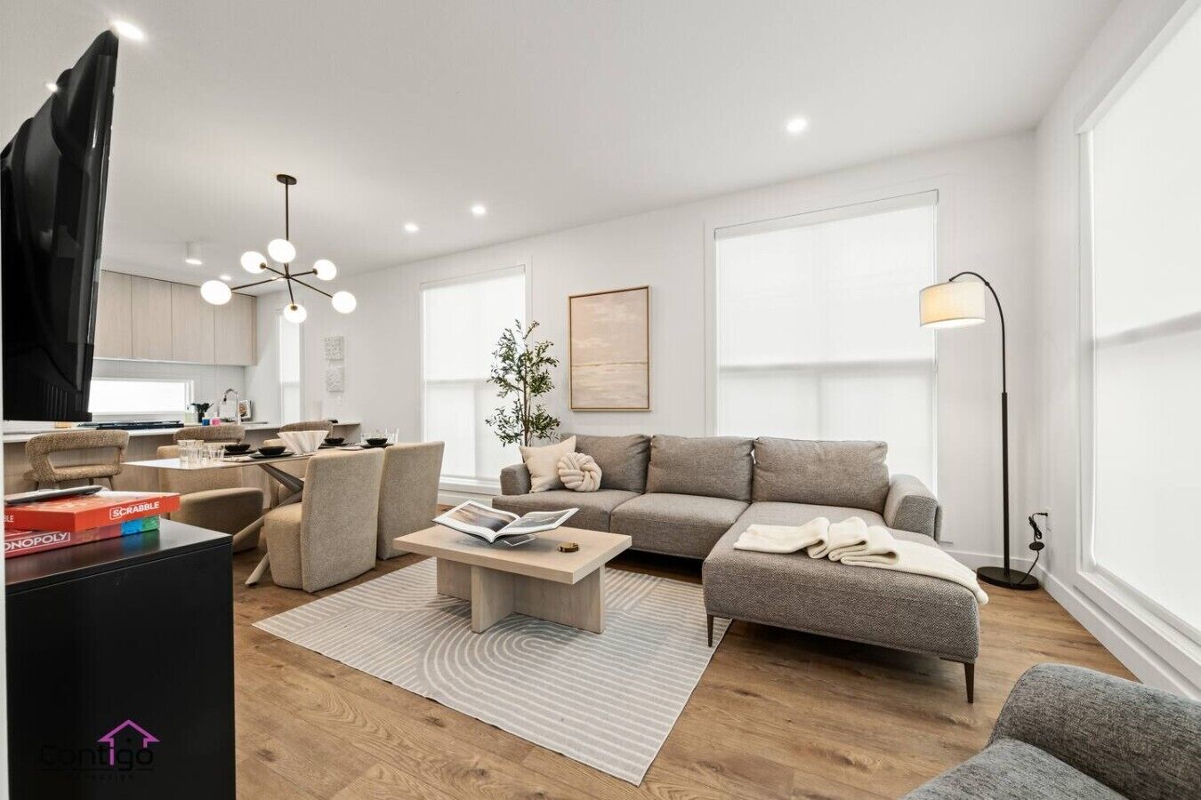 A modern living room with a sofa, coffee table, and a television.