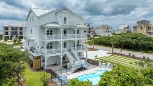 A multi-story white building with a balcony, a swimming pool, and a view of the ocean. - Poolside retreat for large groups (North Topsail Beach)