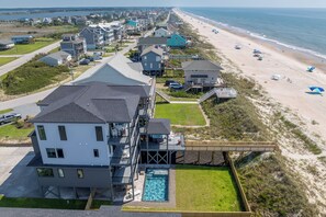 A coastal property with a large house, a swimming pool, and a beach view. - Oceanfront pool retreat for large groups (North Topsail Beach)