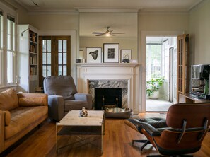 A living room with a fireplace, a sofa, a chair, and a coffee table. - Masters Rental: 3-bedroom house 1 block to Press Headquarters 1 mile to course (Augusta)